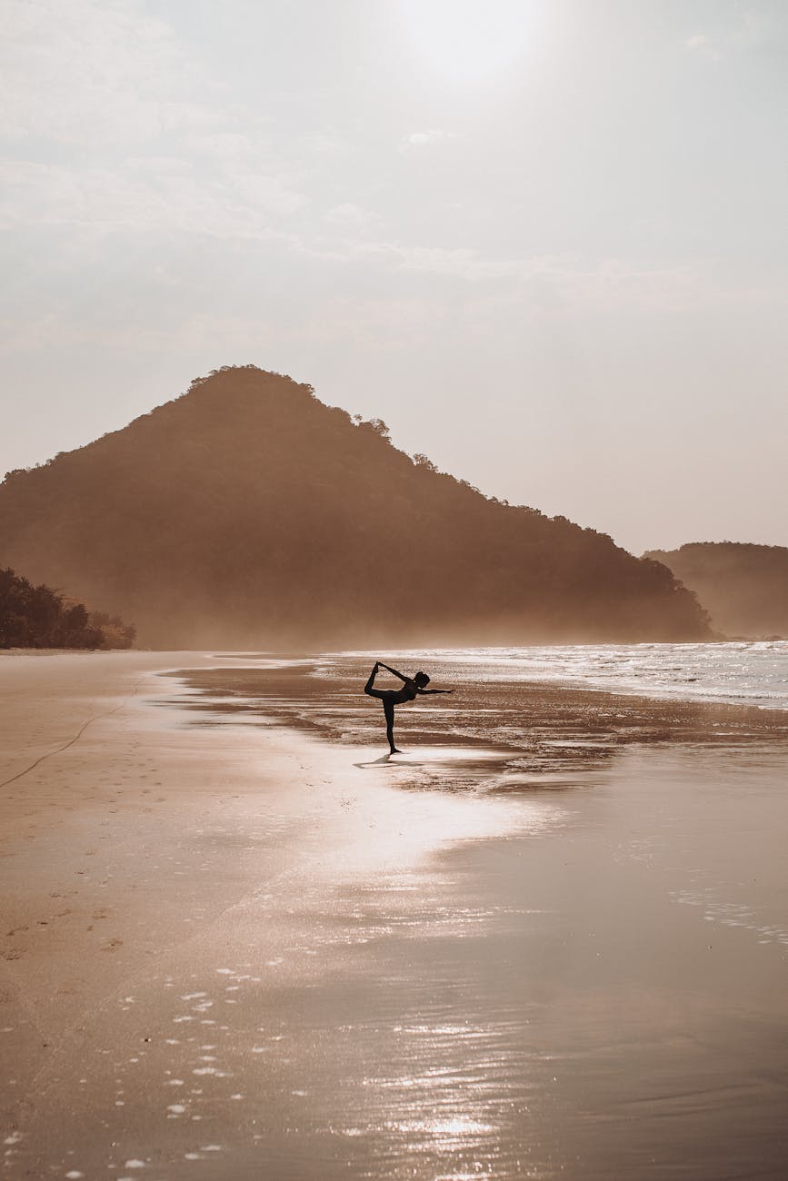woman in yoga pose on beach